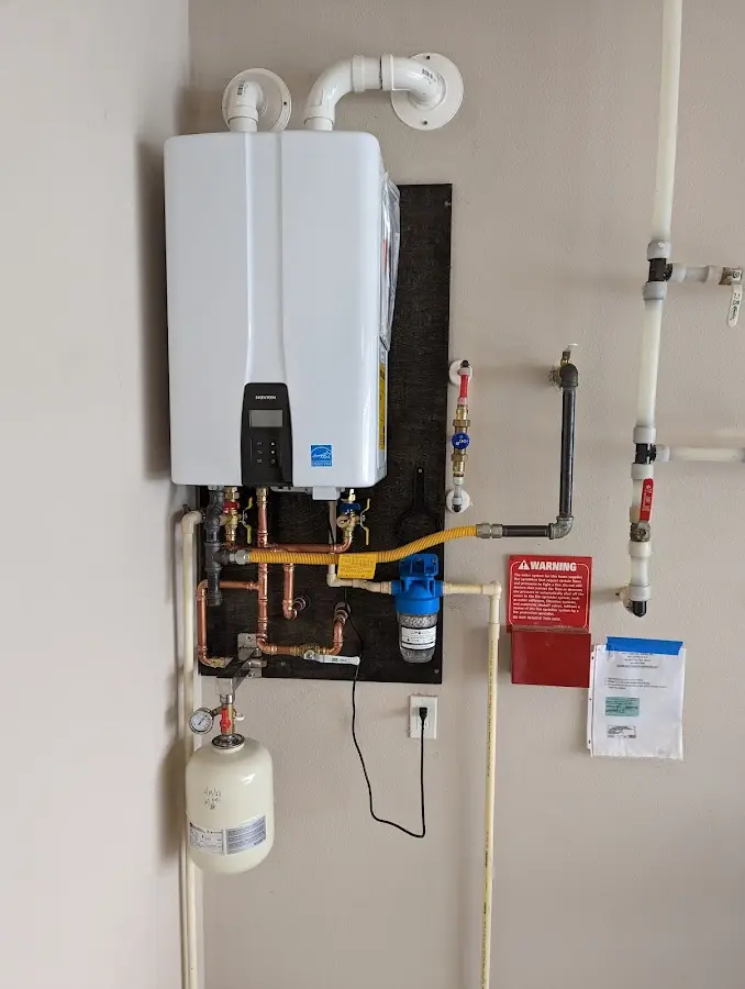 Professional plumber installing copper piping in a Ankeny home